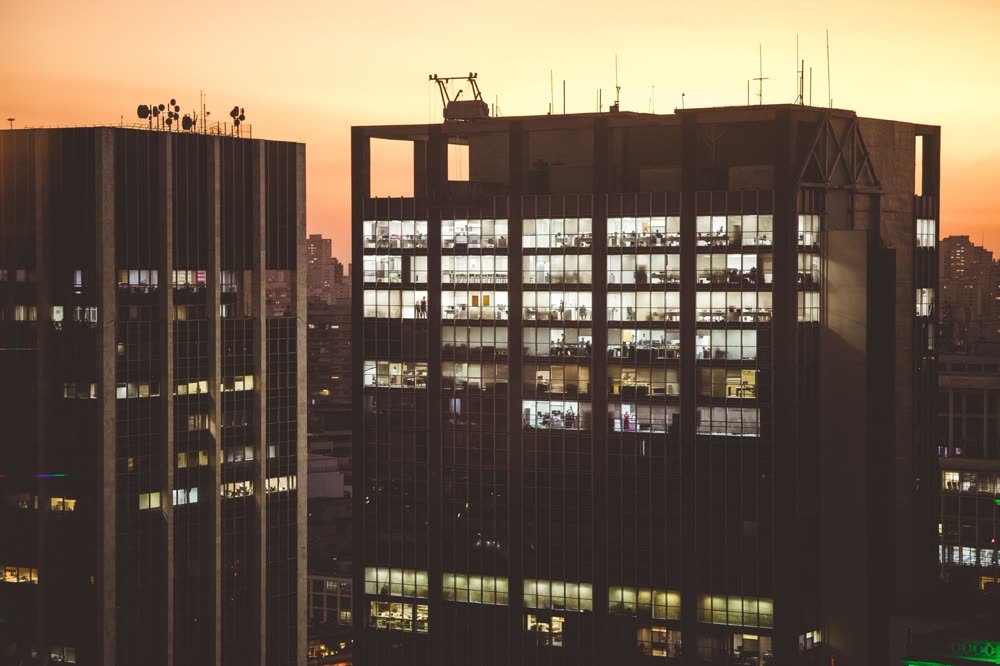 Glass office tower lit at dusk, representing UAE freezone business setup